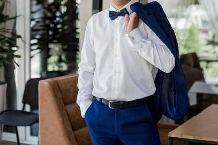 a man in blue suit and bow tie
