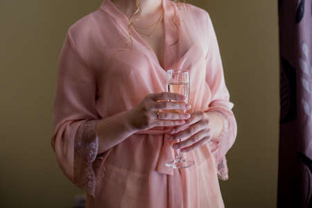 girl in a peignoir and glass of champagneの写真素材