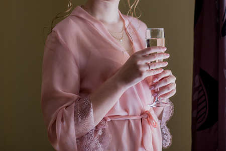 girl in a peignoir and glass of champagneの写真素材