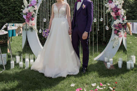 groom with bride near arch of the wedding ceremonyの写真素材