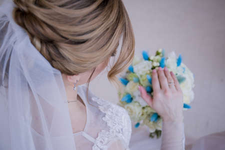the bride's hand on the a wedding bouquetの写真素材