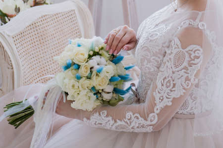 a bride sitting in studio with wedding bouquetの写真素材