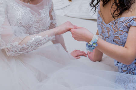 the bride and the girlfriend are hold handsの写真素材