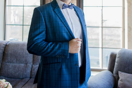 man in suit and bow tie in roomの写真素材