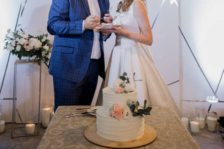 a bride and groom cut wedding cakeの写真素材