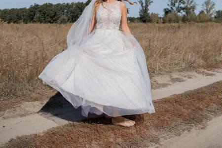 bride in a wedding dress in fieldの写真素材