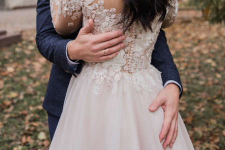 bride and groom in an autumn park at weddingの写真素材