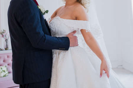 a groom with bride and wedding bouquet in studioの写真素材