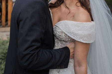 groom with bride and bouquet in parkの写真素材