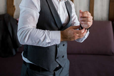 a man puts on a suit in the roomの写真素材