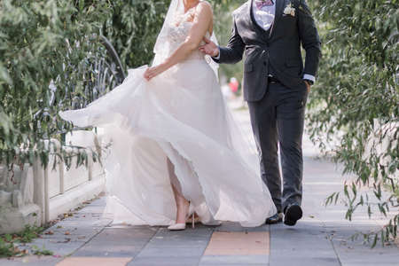 groom with bride on the road in parkの写真素材