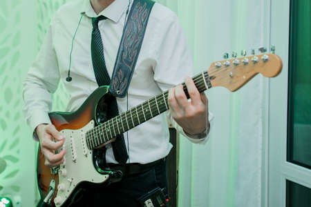 a man playing bass guitar at concert