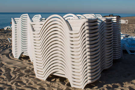 many sun loungers on beach early in the morningの写真素材