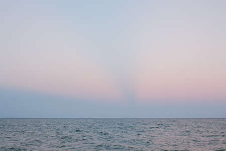 a pink evening sky over the sea