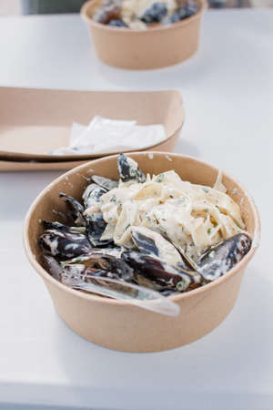 a dish with mussels in shells pasta