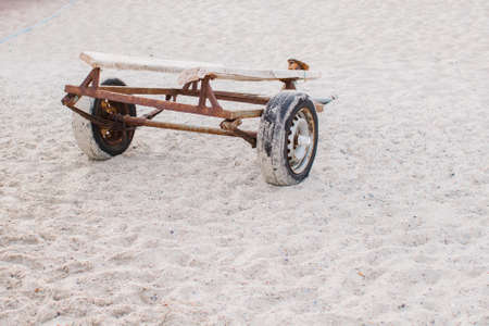 an old trailer on the sandy shoreの写真素材