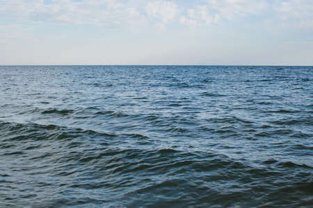 a sea water on the shore and clear sky