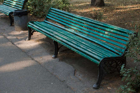 an old green bench in the park