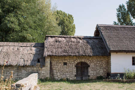 old stone buildings with wooden roof in forestの写真素材
