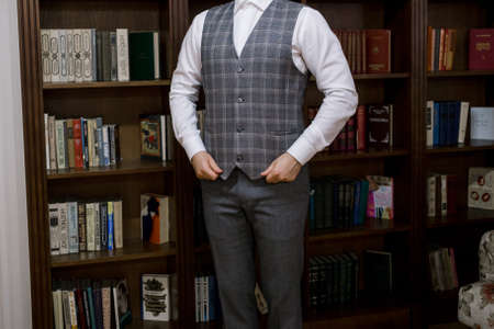 a man puts on a suit in the room