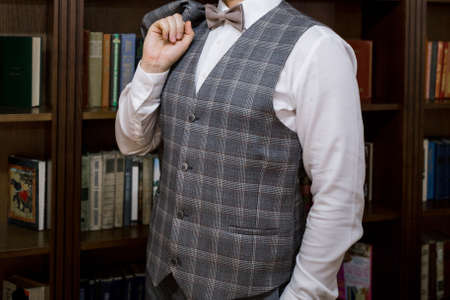 a man puts on a suit in the room