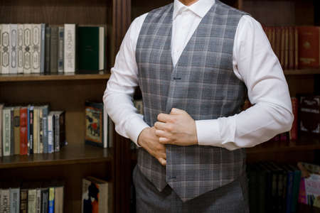 a man puts on a suit in the roomの写真素材