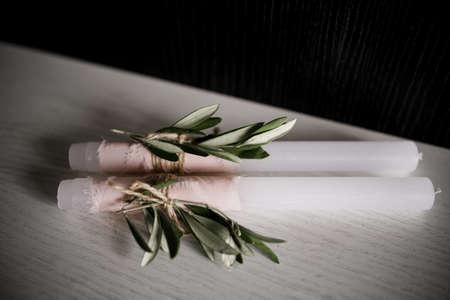 a candle with leaf decor on the tableの写真素材