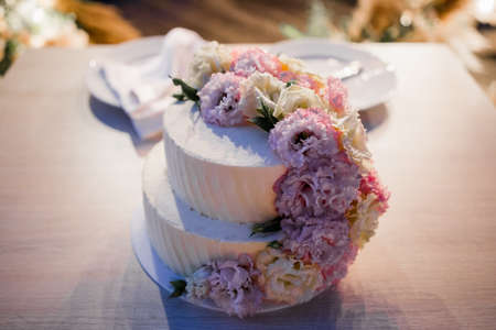 a wedding cake near the arch in the eveningの写真素材