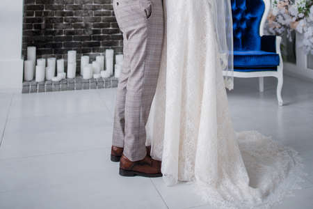 groom and bride in studio hugging togetherの写真素材
