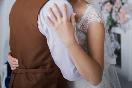 groom and bride in studio hugging togetherの写真素材