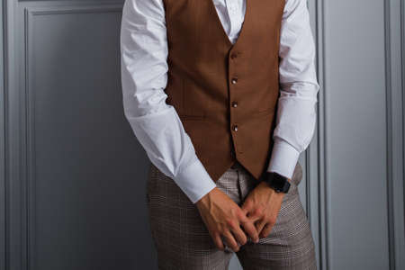 a man in bow tie and vest in the room