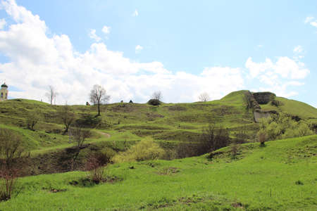 a beautiful green hills near old buildings