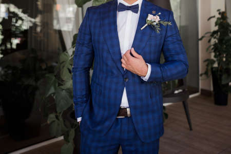 a business man in blue suit with bow tie