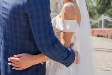 bride and groom together in the park at weddingの写真素材