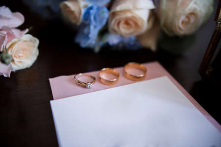 a wedding invitation with bridal bouquet and ringsの写真素材