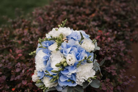 bridal bouquet flowers with gold wedding rings