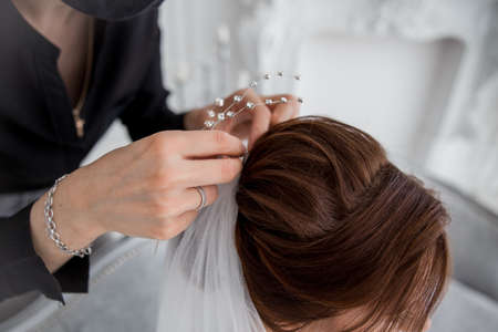 a bride wear a veil in her hair in the morningの写真素材
