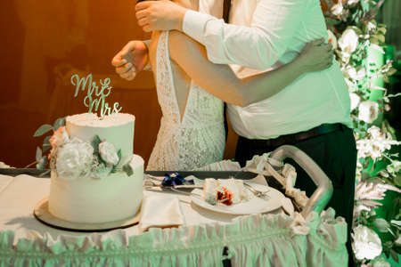 bride and groom at the wedding cut the wedding cakeの写真素材