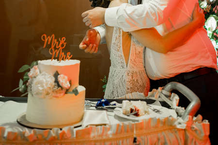 bride and groom at the wedding cut the wedding cakeの写真素材