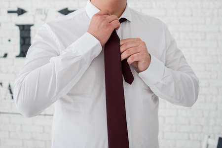 the groom is going to get dressed for the wedding in morningの写真素材