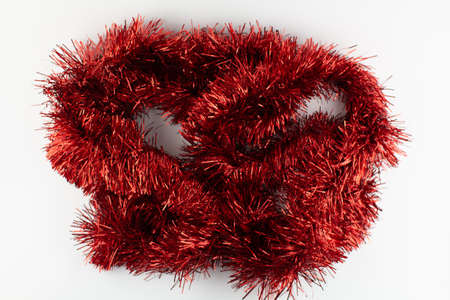 a red garland for christmas on a holiday background