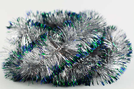 a silver garland for christmas on a holiday background
