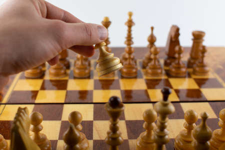 man takes a step with a chess piece