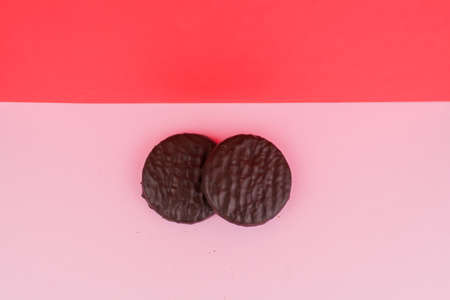 a chocolate chip cookies on pink background