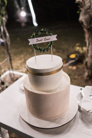 beautiful white wedding cake in the evening in parkの写真素材