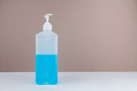 a bottle with blue antiseptic on table with backgroundの写真素材
