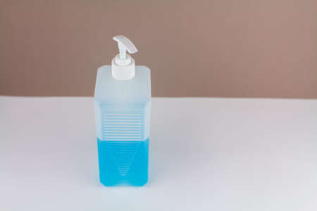 a bottle with blue antiseptic on table with backgroundの写真素材