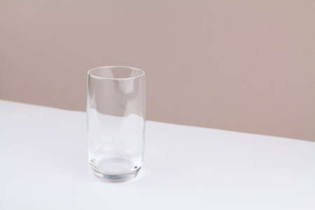 a glass cup on white brown background stylish in the kitchenの写真素材