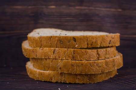 a sliced bread on a dark wood table