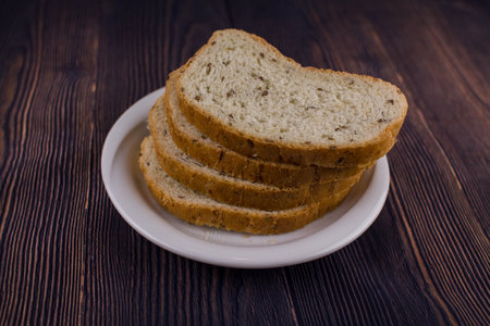a sliced bread on a dark wood table